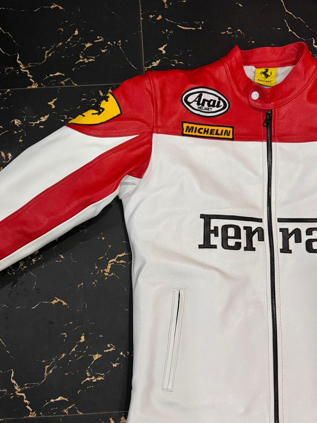Front view of Ferrari red and white racing leather jacket with Arai and Michelin logos