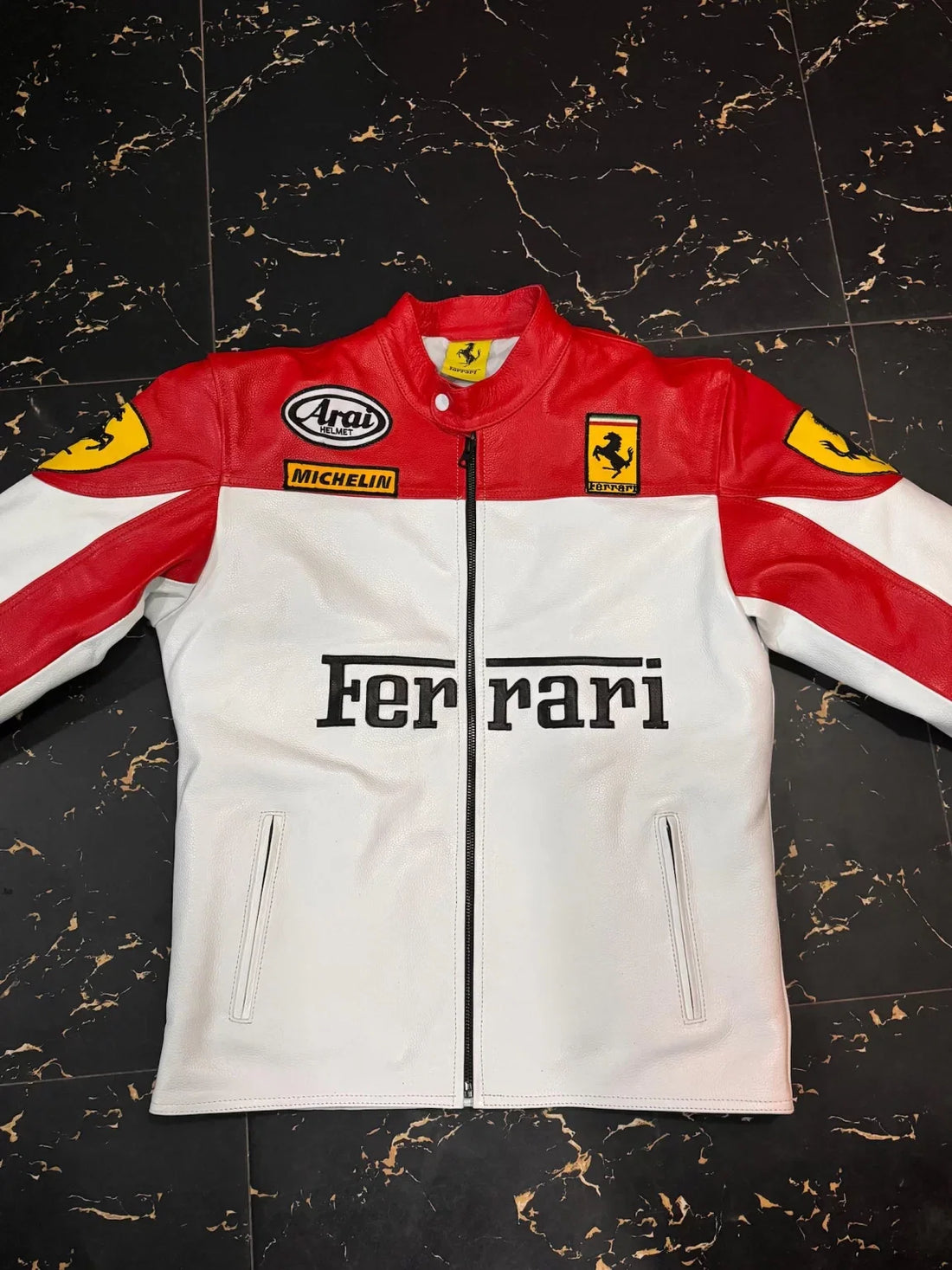 Front view of Ferrari red and white racing leather jacket with Arai and Michelin logos