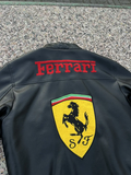 Back view of the black Ferrari F1 leather jacket showing the large red 