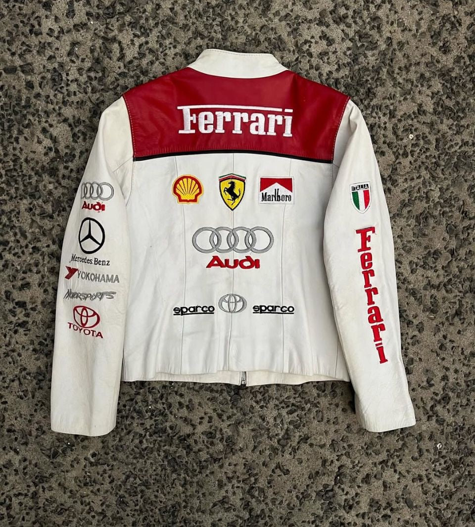 Back view of the white and red racing jacket, highlighting large Ferrari, Shell, Marlboro, and Audi sponsor logos.